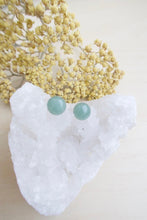 Load image into Gallery viewer, Green aventurine earrings on surgical steel posts sitting on a white crystal