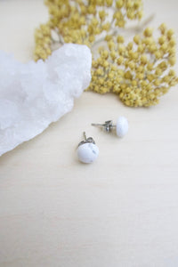 Simple white stud earrings on hypoallergenic skin friendly surgical steel posts