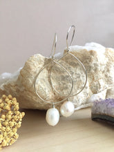 Load image into Gallery viewer, Sterling silver hoop earrings with a white freshwater pearl drop hanging from the hoop