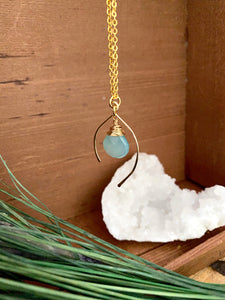 Sea Foam or Aqua blue gemstone drop wire wrapped and anclosed in an open wish bone shaped frame. Suspended from a 16 inch chain