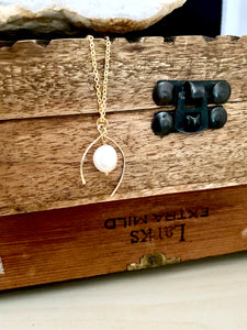 Asymmetrical 14k gold fill frame with a white freshwater pearl drop enclosed in the frame. Susupended from a 16 inch chain