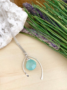 Aqua Blue Chalcedony pendant anclosed in a sterling silver wishbone frame and suspended from a 16 inch chain 